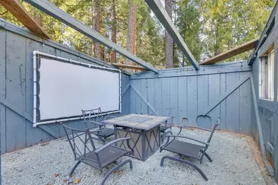a table and chairs and a whiteboard in a building at Fire Pit and Grill Retreat Between Arnold and Murphys in Hathaway Pines