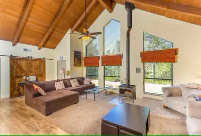a living room with a couch and a table at Cody's Comfy Cabin- Near Yosemite in Mariposa