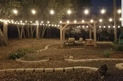 a garden at night with a gazebo with lights at Cody's Comfy Cabin- Near Yosemite in Mariposa