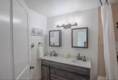 a bathroom with a sink and a shower at Cody's Cozy Cottage-Near Yosemite in Mariposa