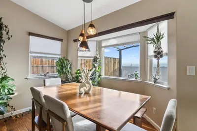 a dining room with a table and chairs and windows at Spacious Cozy and Furnished Bedroom Private Bathroom, Close to Everything in Reno