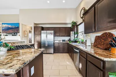 a large kitchen with wooden cabinets and stainless steel appliances at Spacious Cozy and Furnished Bedroom Private Bathroom, Close to Everything in Reno