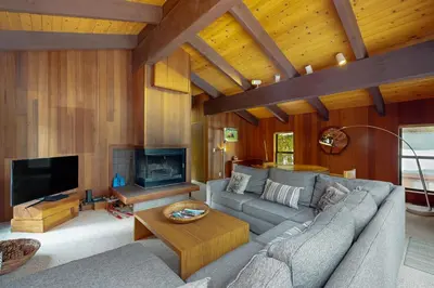 a living room with a couch and a tv at Wolf Tree Wonder in Truckee