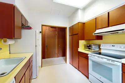 a kitchen with wooden cabinets and a white refrigerator at Wolf Tree Wonder in Truckee
