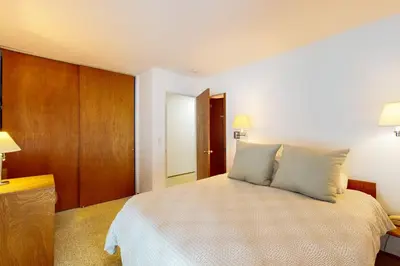 a bedroom with a large bed with two pillows at Wolf Tree Wonder in Truckee