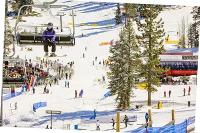 a group of people on a ski lift in the snow at Wolf Tree Wonder in Truckee
