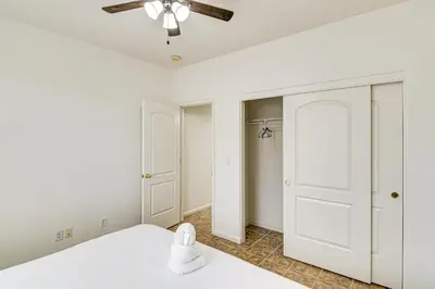 a bedroom with a white bed and a ceiling fan at Family Reno Home with Game Room! 28 Mi to Ski Resort in Reno