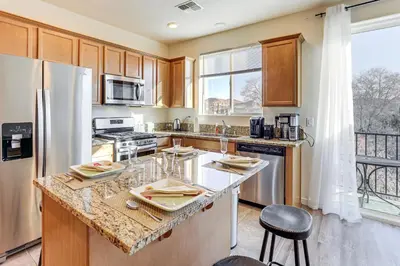 a kitchen with a counter and a refrigerator at 4 Mi to Dtwn Family-Friendly Townhome in Reno in Reno