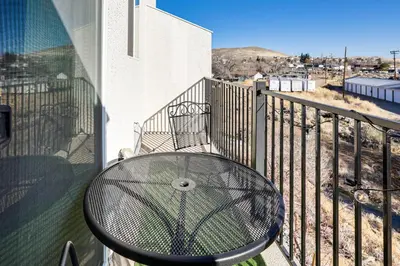 a table on a balcony with a view of a city at 4 Mi to Dtwn Family-Friendly Townhome in Reno in Reno