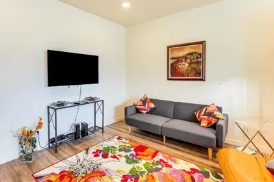 a living room with a couch and a flat screen tv at 4 Mi to Dtwn Family-Friendly Townhome in Reno in Reno