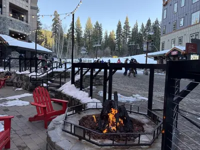 a fire pit in a courtyard with a red chair at Timber Creek 309 condo in Truckee