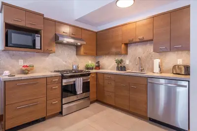 a kitchen with wooden cabinets and stainless steel appliances at Timber Creek 309 condo in Truckee