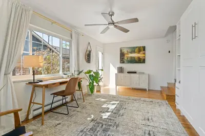 a living room with a desk and a ceiling fan at Cozy Reno Midtown Retreat Fire Pit & Parking in Reno