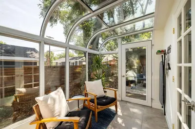 a screened in porch with two chairs and windows at Cozy Reno Midtown Retreat Fire Pit & Parking in Reno