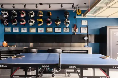 a ping pong table in a room with helmets on the wall at Marlin Cove Pet Friendly Waterfront Retreat in Discovery Bay