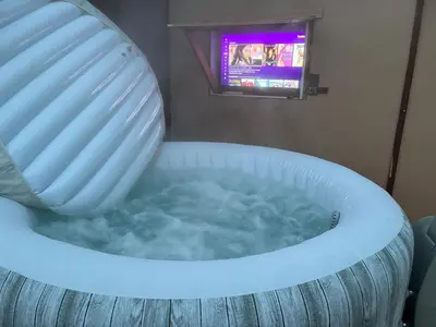 a bath tub with a tv in a room at Epic View Hot tub National forest in Wofford Heights