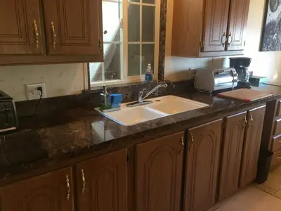 a kitchen counter with a sink and a microwave at Epic View Hot tub National forest in Wofford Heights
