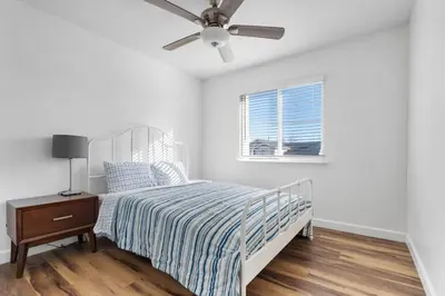 a white bedroom with a bed and a ceiling fan at 4 bedroom Home in Tracy 2 Minutes to Highway in Tracy
