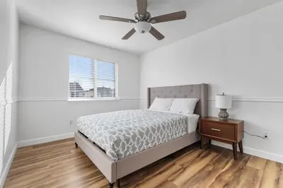 a bedroom with a bed and a ceiling fan at 4 bedroom Home in Tracy 2 Minutes to Highway in Tracy