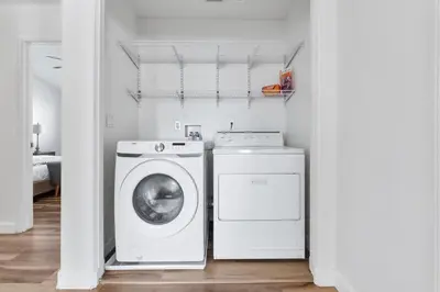 a laundry room with a washing machine and a washer at 4 bedroom Home in Tracy 2 Minutes to Highway in Tracy