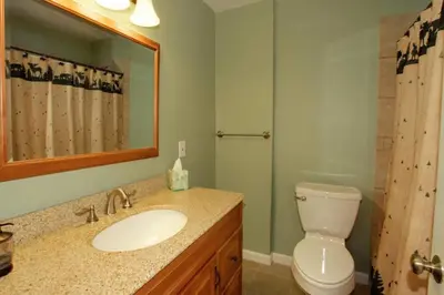 a bathroom with a sink and a toilet and a mirror at Ormsby House 1489O in South Lake Tahoe