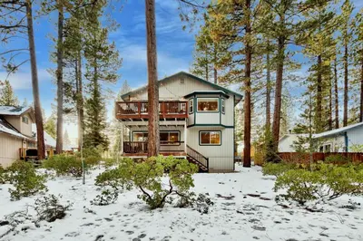 a house in the snow with trees at Kamp Koyukon 1939K in South Lake Tahoe