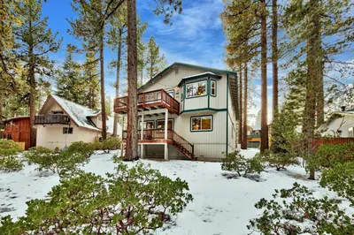 a house in the woods with snow on the ground at Kamp Koyukon 1939K in South Lake Tahoe