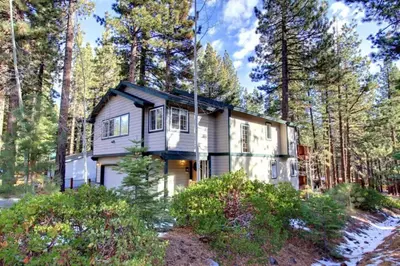 a house in the woods with trees at Kamp Koyukon 1939K in South Lake Tahoe