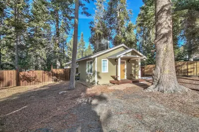 a small house in the middle of a forest at 1540TS Snowy Owl Cabin in South Lake Tahoe