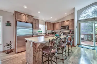 a kitchen with a large island with bar stools at 2272L The Lupine Lodge in South Lake Tahoe