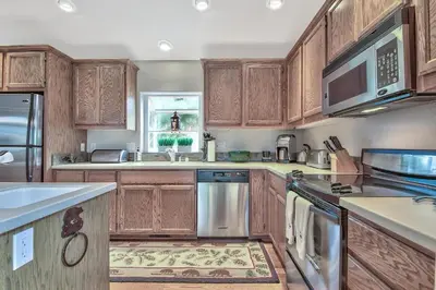 a kitchen with wooden cabinets and stainless steel appliances at 2272L The Lupine Lodge in South Lake Tahoe