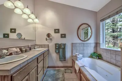 a bathroom with two sinks and a tub and a mirror at 2272L The Lupine Lodge in South Lake Tahoe