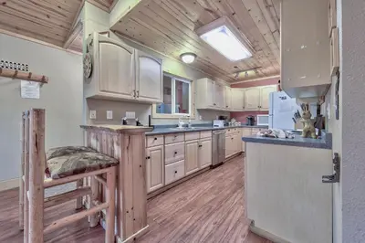 a large kitchen with wooden cabinets and a skylight at 1965NP The Bears Den in South Lake Tahoe