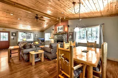 a dining room and living room with a wooden ceiling at 1965NP The Bears Den in South Lake Tahoe