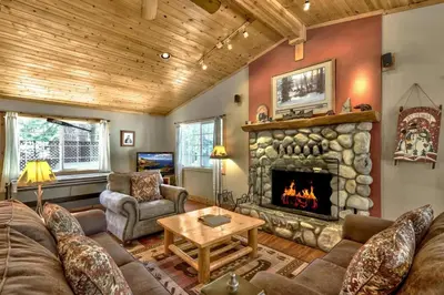 a living room with a couch and a fireplace at 1965NP The Bears Den in South Lake Tahoe