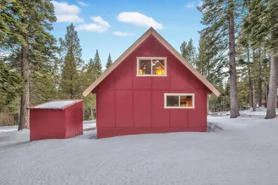 a red shed in the snow with trees at Cholula Chalet 811C in South Lake Tahoe