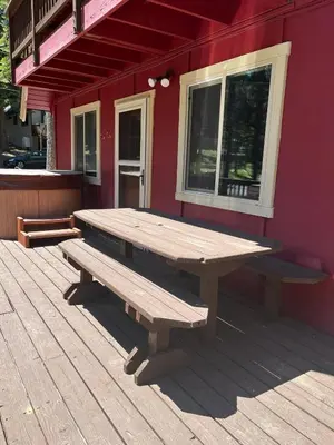 a wooden picnic table on a deck outside of a building at Cholula Chalet 811C in South Lake Tahoe