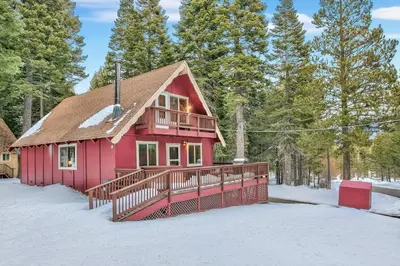 a red house with a deck in the snow at Cholula Chalet 811C in South Lake Tahoe