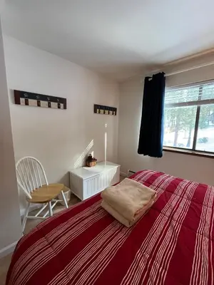 a bedroom with a bed and a chair and a window at 121M The Meadow Drive in Stateline