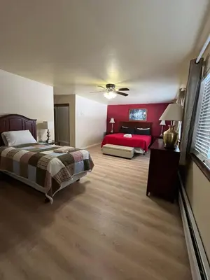 a large bedroom with a bed and a red bedspread at 121M The Meadow Drive in Stateline