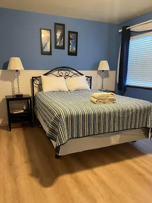 a bedroom with a bed with blue walls and two lamps at 121M The Meadow Drive in Stateline