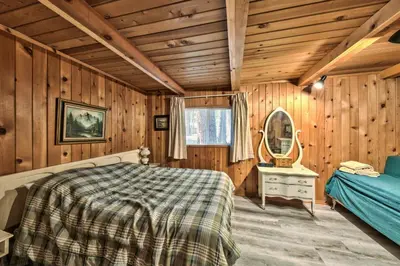 a bedroom with wooden walls and a bed and a mirror at Hank Monk Chalet 2730HM in South Lake Tahoe