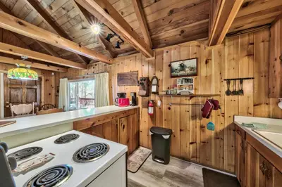 a kitchen with wooden walls and a stove in a cabin at Hank Monk Chalet 2730HM in South Lake Tahoe
