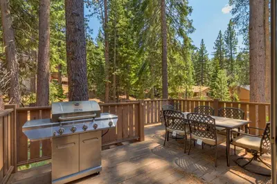 a grill on a deck with a table and chairs at The Westlands Lodge 1135AC in South Lake Tahoe