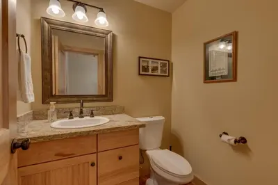 a bathroom with a toilet and a sink and a mirror at The Westlands Lodge 1135AC in South Lake Tahoe