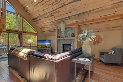 a living room with a leather couch and a fireplace at The Westlands Lodge 1135AC in South Lake Tahoe