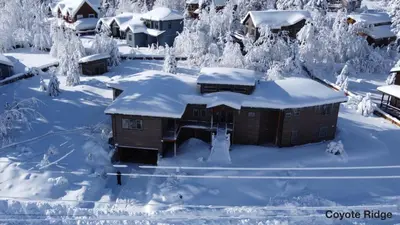 a house covered in snow with trees and houses at 1044C Coyote Ridge in South Lake Tahoe