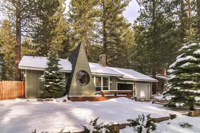 a small house in the woods in the snow at 2574C Bear Creek Cabin in South Lake Tahoe