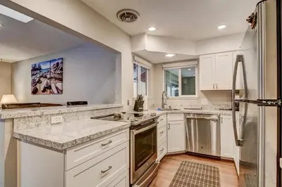 a kitchen with white cabinets and a refrigerator at 2574C Bear Creek Cabin in South Lake Tahoe