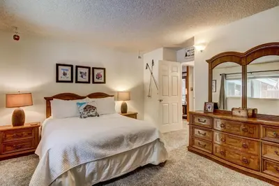 a bedroom with a bed and a dresser and a mirror at 2574C Bear Creek Cabin in South Lake Tahoe